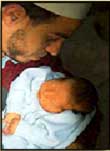 Muslim Priest with  a new born child